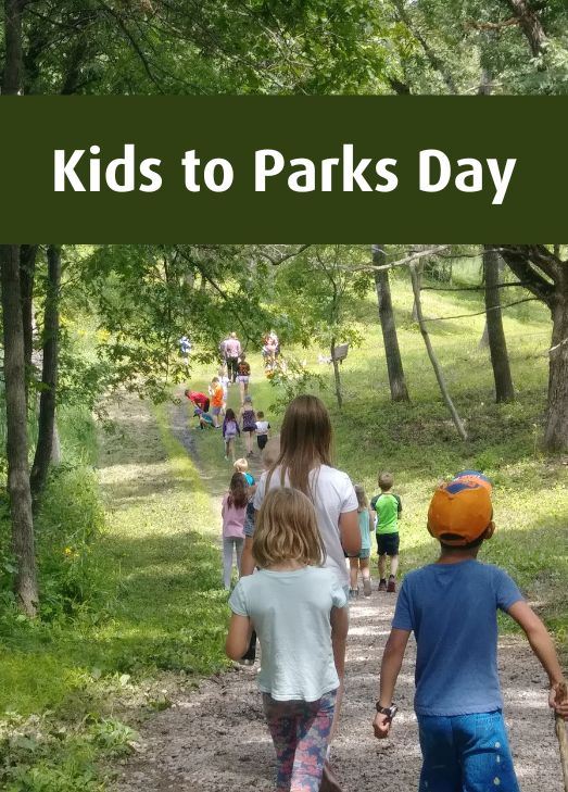 Kids to Parks Trail Day headline over tree leaves