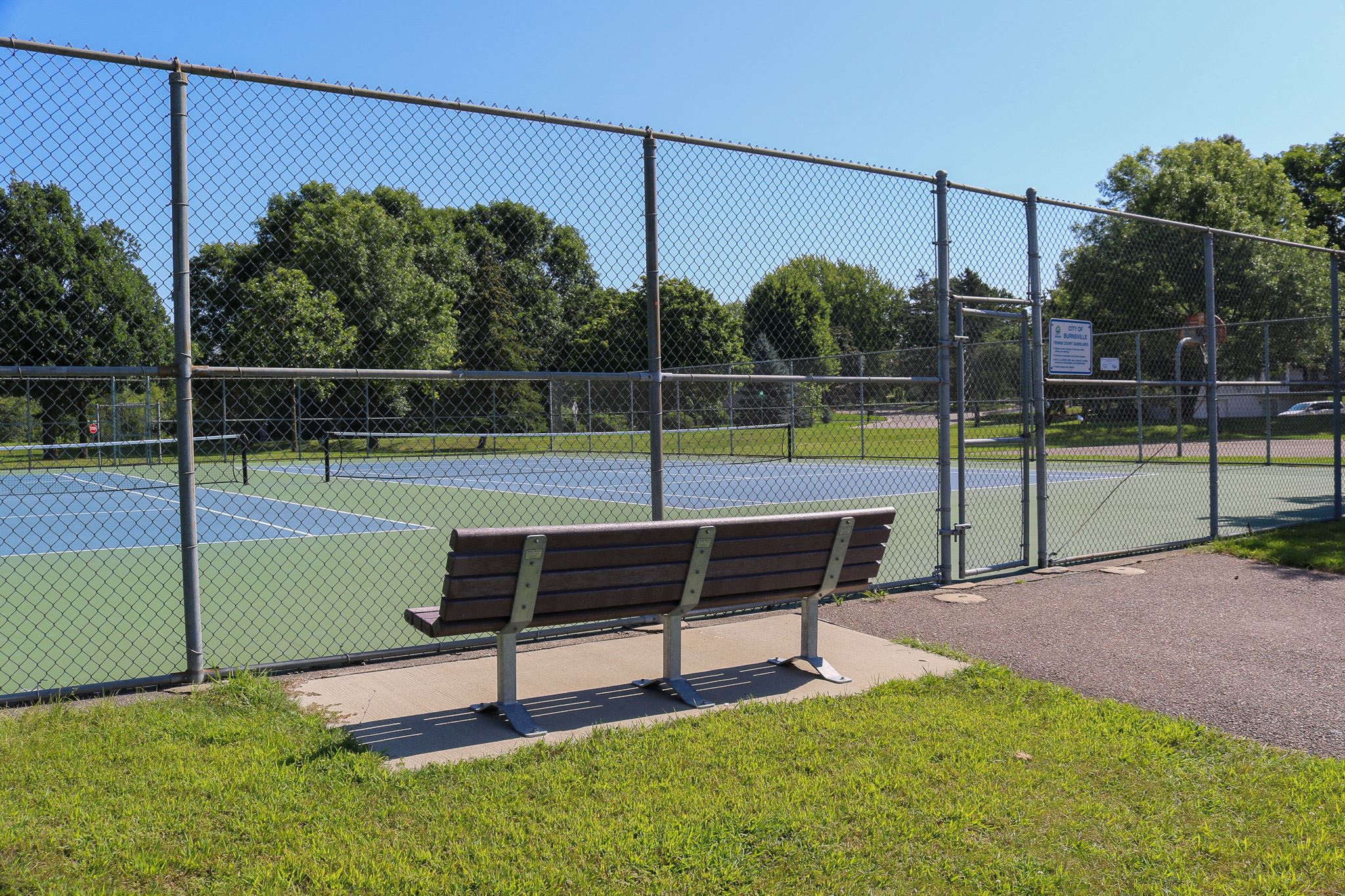 Terrace Oaks East tennis courts and park bench
