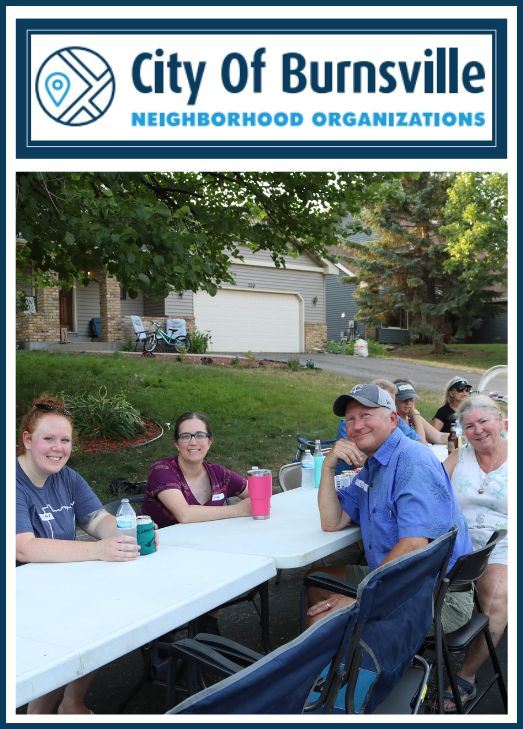 Neighbors sitting at a table at block party