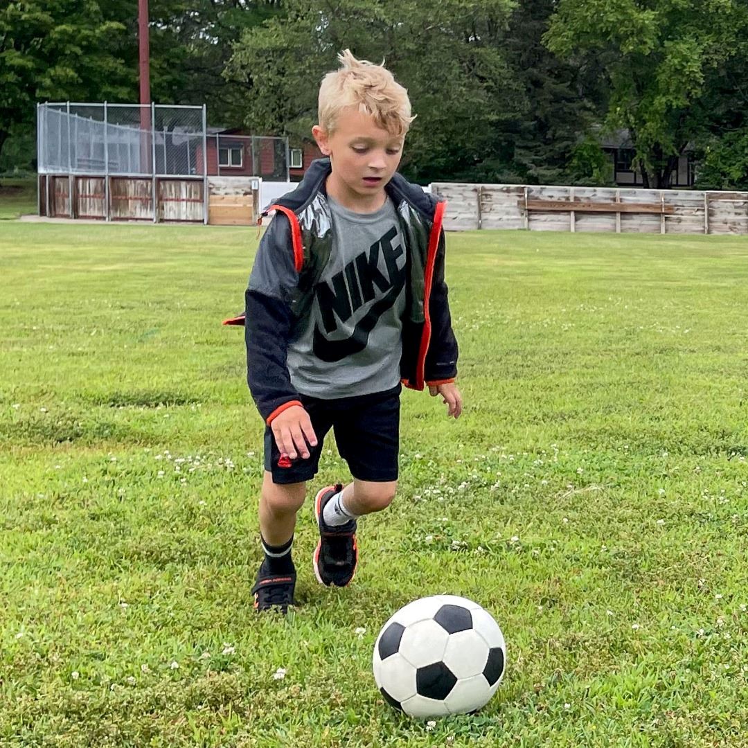 boy kicking soccer ball