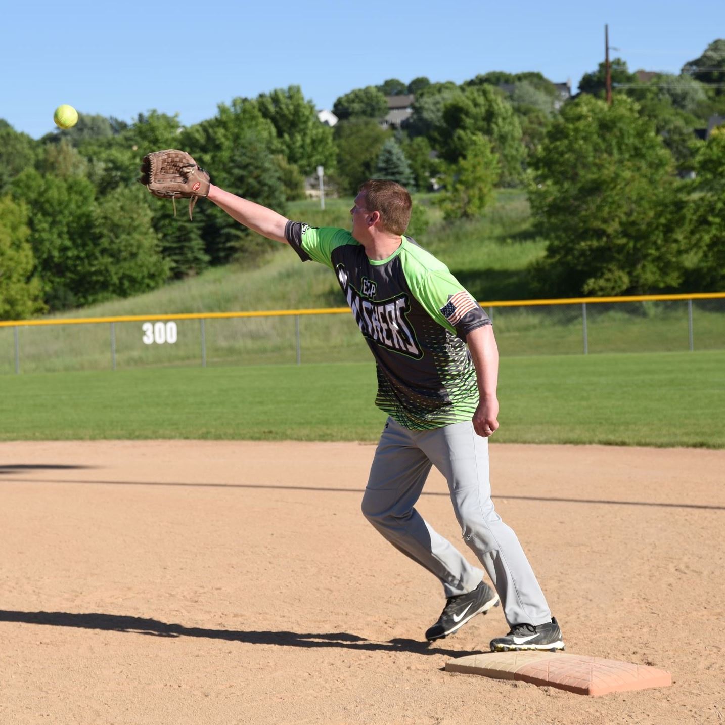 First base player catching softball